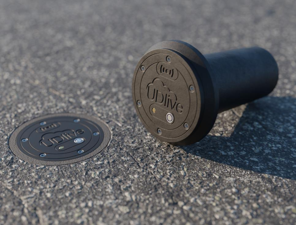 Image of the UDlive Road Temperature Sensor installed as well as uninstalled Sensor on the ground beside it.